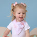 Toddler wearing Coral Organic Dribble Bib | Snuggle Hunny