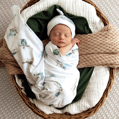 Baby wrapped in Turtle Organic Jersey Wrap & Beanie Set | Snuggle Hunny